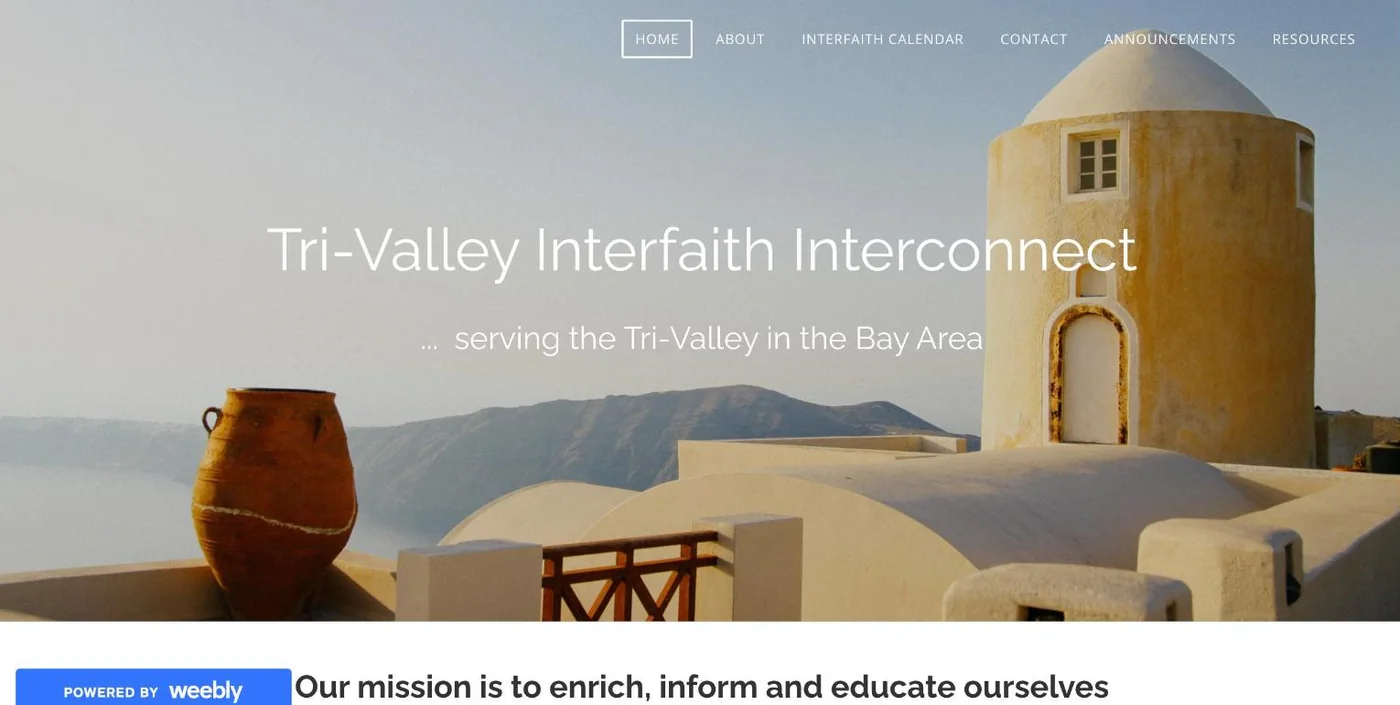 The old Interfaith Interconnect homepage on Weebly: a stock photo of a Greek island with the title in thin white text